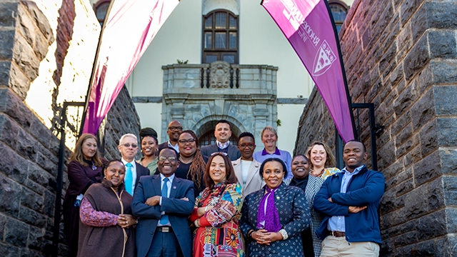 Rhodes University and Allan Gray representatives on the steps of the Main Administration Building