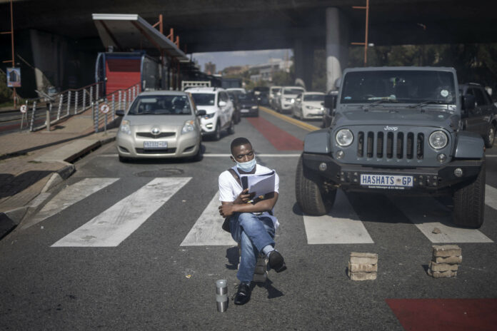  Image: A person sits on bricks pretending to read as students block traffic in Braamfontein, Johannesburg, on March 10, 2021. Photo by Michele Spatari/AFP.
"The University has resorted to scare tactics in
order to silence the cries of students. We will not be intimidated by a
university that has chosen the side of the oppressor and insists on telling
half-truths."