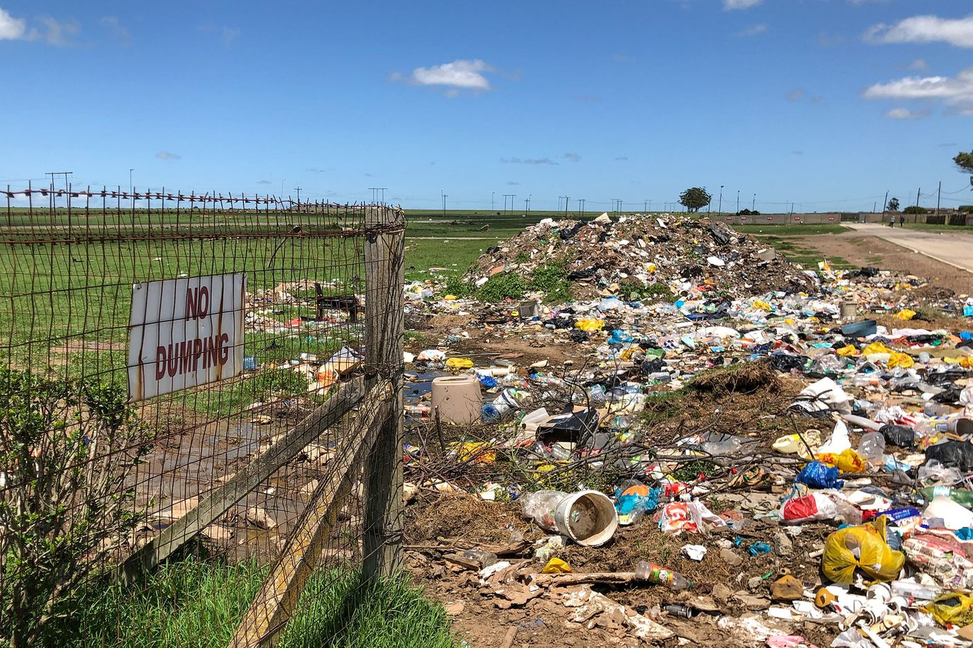 Trash accumulates on the side of a street in the township of Joza. Photographer: Michael Cohen/Bloomberg