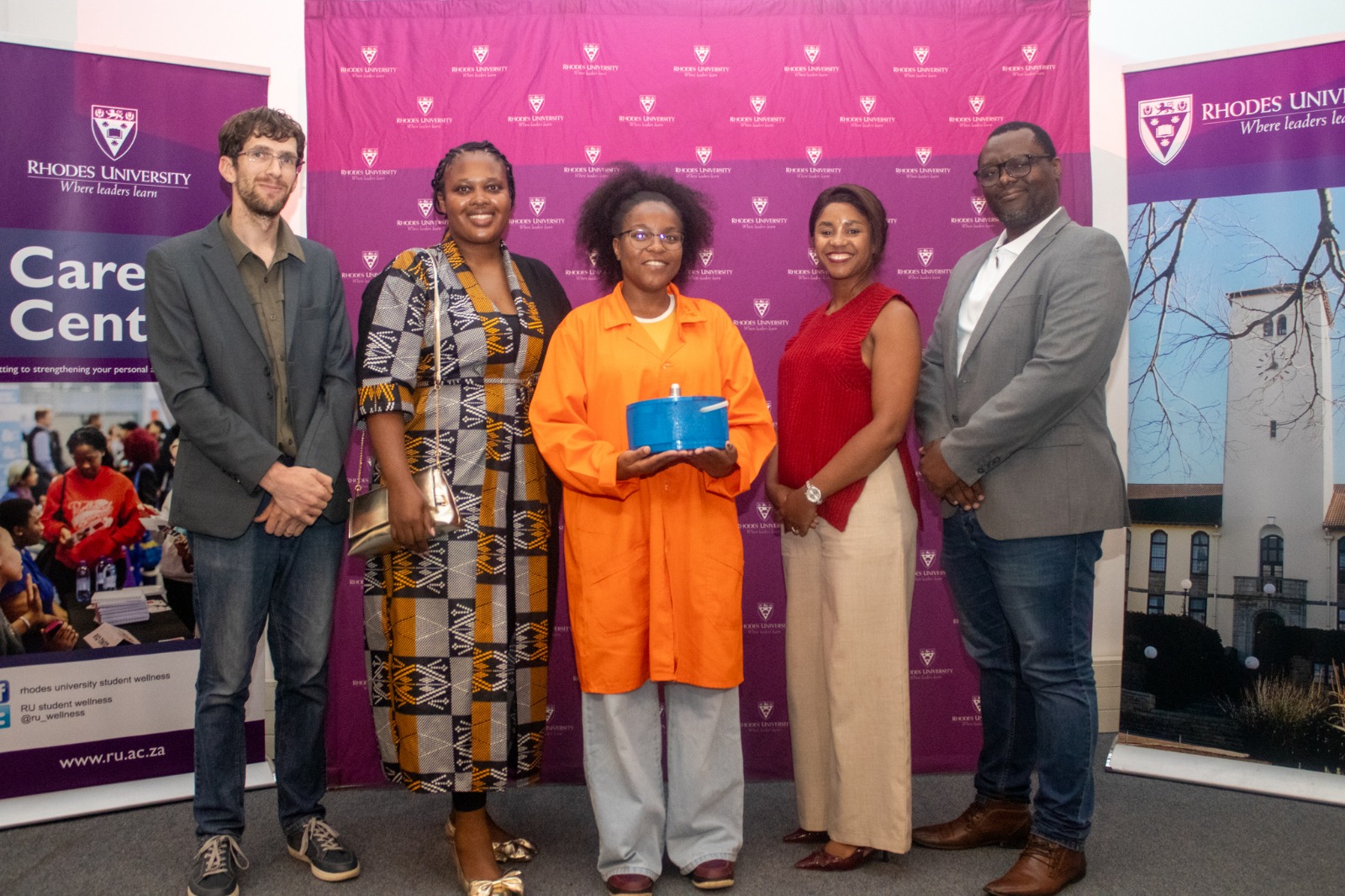 Hult Prize On-Campus Finals winner, Paula Maseko of MOFify, with the competition's panel of judges. 
Pictured from left to right: Dr Michael Jukes, Ms Heide Khuhlane, Ms Paula Maseko, Mrs Milisa Mamase, and Dr Matolwandile Mtotywa [PHOTO CREDIT: Vusumzi Tshekema]