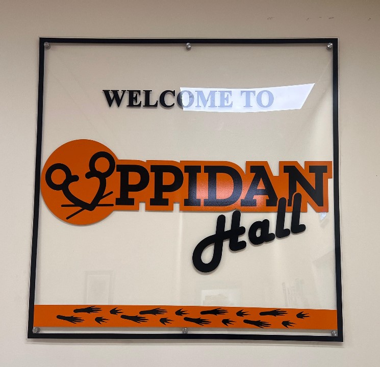 Some amenities available within the Oppidan Common Room include a microwave, television, couches, and desks.