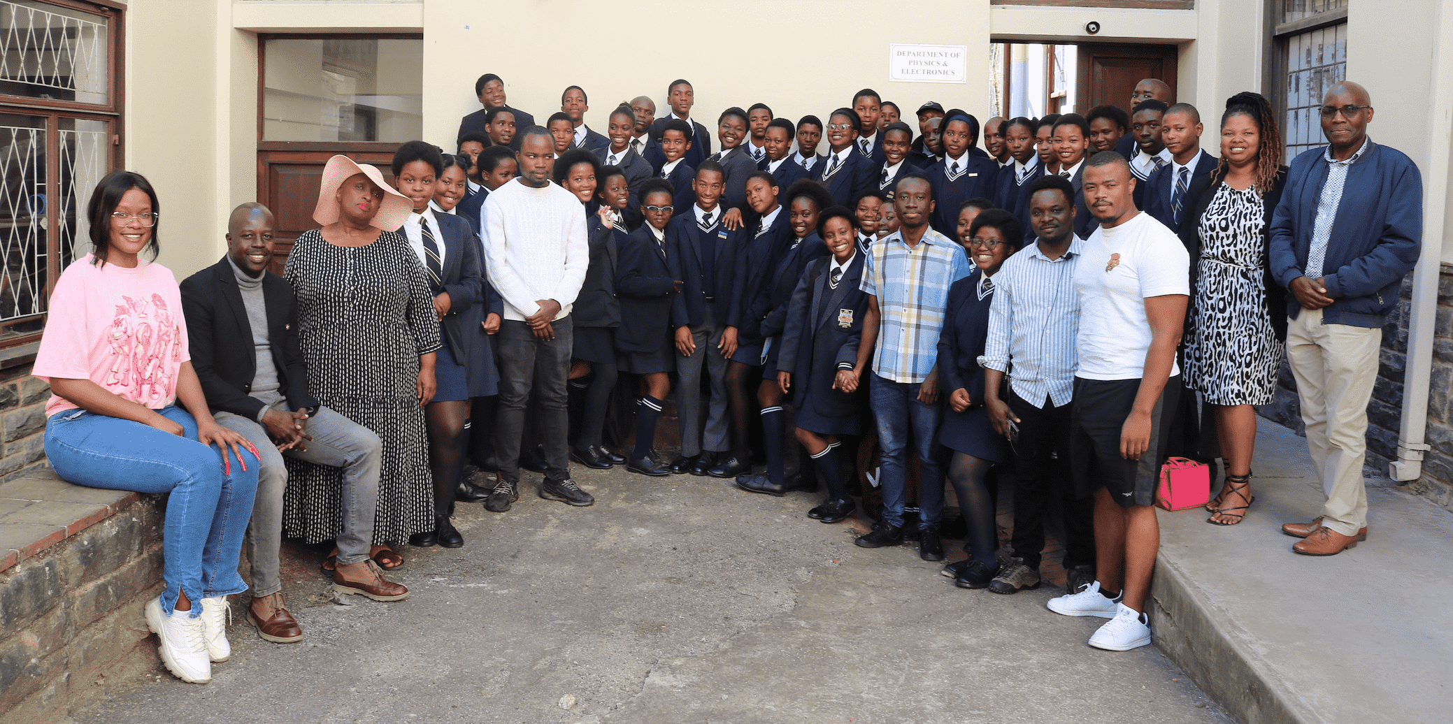 Lecturers and learners outside of the Physics and Electronics building