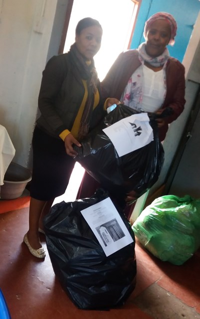 Vathiswa handing over waste for activities in the local pre-schools