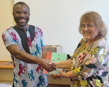 Professor Jill Slinger handing Prof Nelson Odume a copy of Building with Nature.