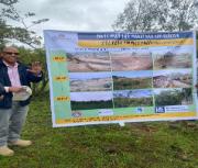 Dr Amare from WLRC showing the pictures of the progress in the two Watershed Management development to farmers during the learning exchange