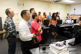 The audience watch carefully as the calligraphers paint on the Design lab walls