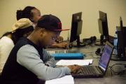 A student works on his laptop during the social media bootcamp at Rhodes JMS