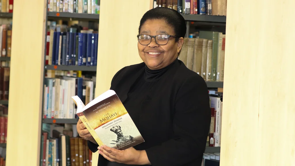 Library and Information Services Director, Nomawethu Danster with S.E.K. Mqhayi's book. 