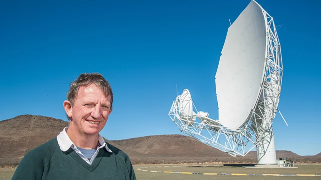 Professor Justin Jonas with a MeerKAT Radio Telescope antenna