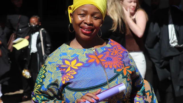 Thembi Msibi holds her mother's degree parchment