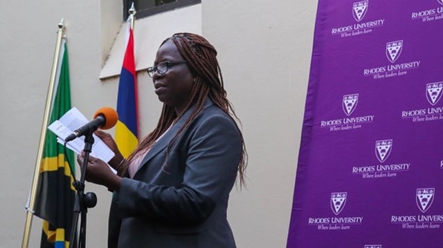 Distinguished Professor Marcelline Tchassim reading a poem to the audience