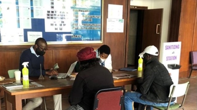 Pharmacy Faculty pharmacists Dr Makoni and Ms Magadza help Rhodes employees register on the EVDS system.