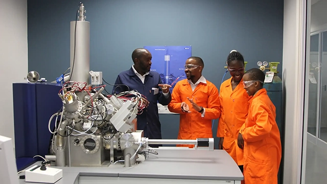 Associate Professor Philani Mashazi of Rhodes University, working with postgraduate students Ridge Chavalala, Winnie Lubisi and Renielwe Shiane on the Time-of-Flight Secondary Ion Mass Spectroscope (TOF-SIMS). Image: Chris Marais.